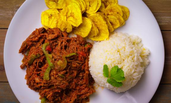 Ropa vieja (shredded beef) with white rice and plantain chips