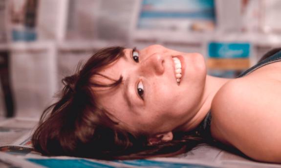 Songwriter Callum Toner lying on back, looking at camera sideways