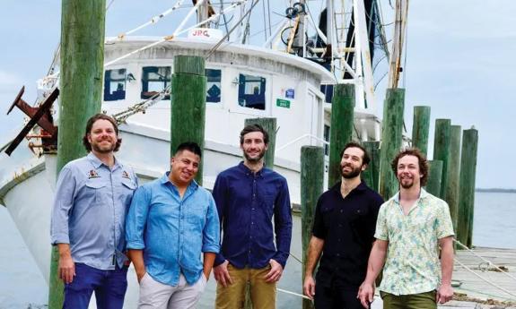 The band Gilberto '77 on the deck of a shrimp boat