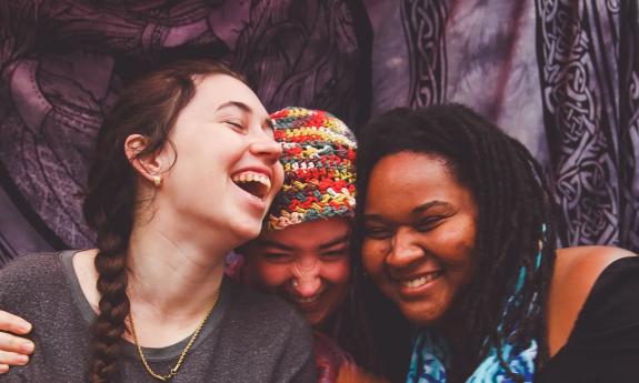 Music trio Little Mercies laughing together onstage