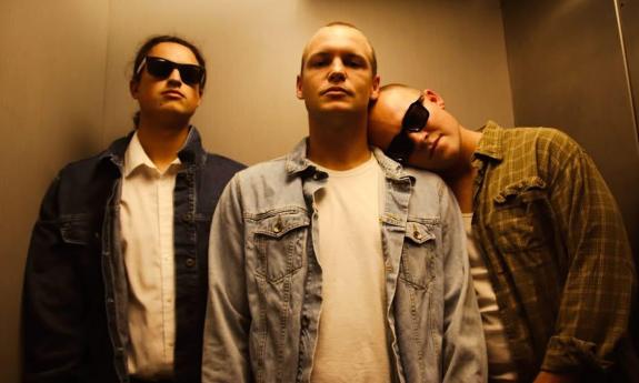 Three band members in an elevator
