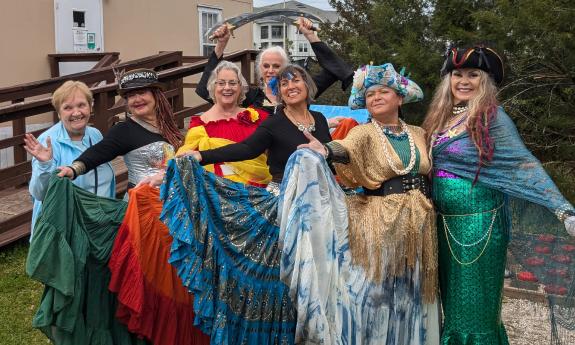 Seven women, dressed as gypsy dancers