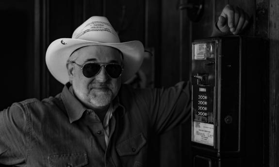 The singer leaning on a pay phone