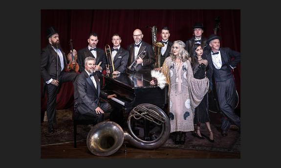 The Squirrel Nut Zipers, around a piano in tuxes and 1920 gowns