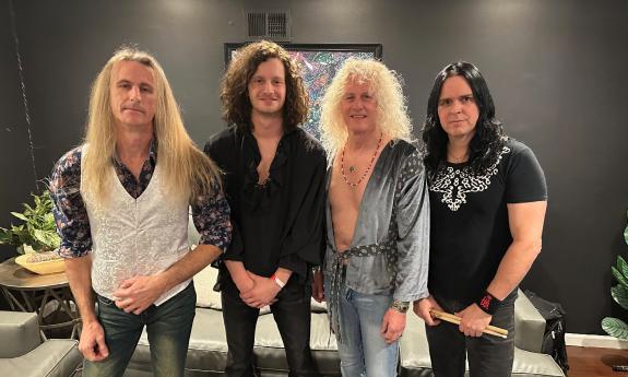 The four members of Zoso, the Led Zeppelin Tribut Band, standing in a lounge before a concert