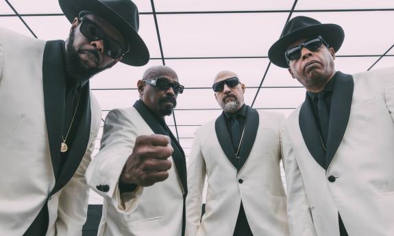 Bandmates from Cypress Hill don white and black suits and pose for fans. 