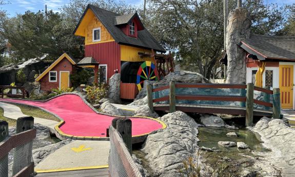 A bright red "green" at Anastasia Miniature Golf