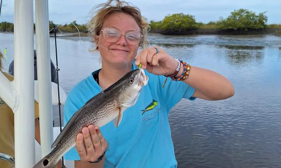 A small fish caught onboard by a young guest