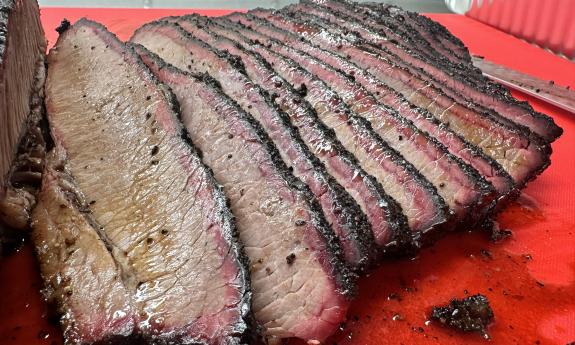 Thinly-sliced brisket on a cutting board