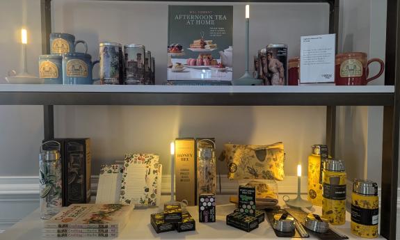 Two shelves of home decor, highlighted by modern lamps
