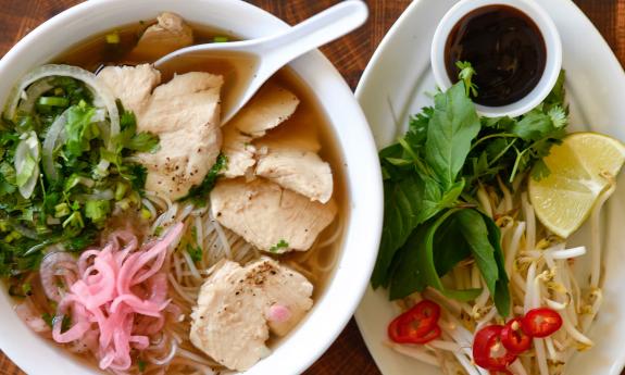 A pho bowl with an assortment of toppings and sauce