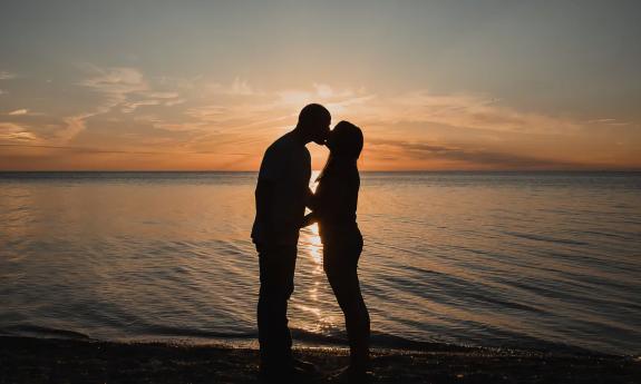 A couple posing during a beach sunset