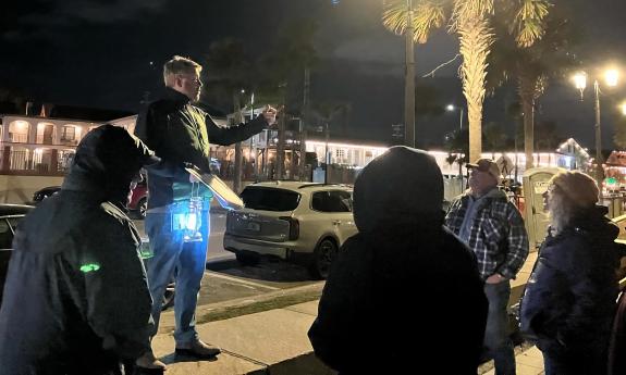 A tour guide talking during the Dark History Tour