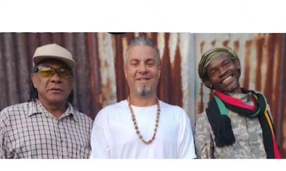 The band Part One Tribe standing in front of a rusty corrugated wall