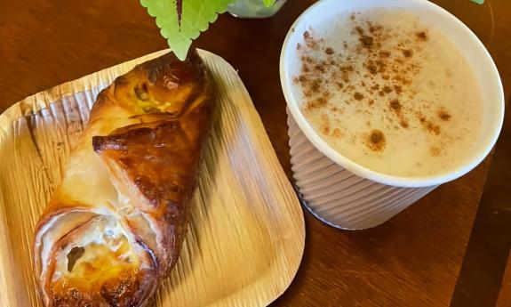 A pastry and hot beverage served