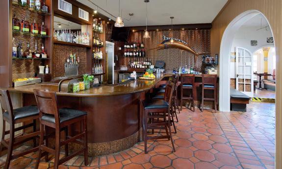 Harry's Bar has wood panneling and red tile floors