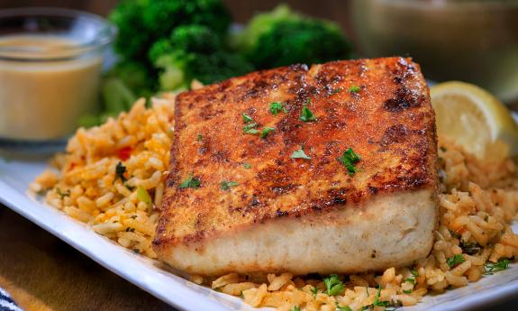 Blackened mahi on a bed of colorfool nola rice at Harry's