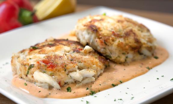 Harry's crabcakes arranged on a bed of sauce