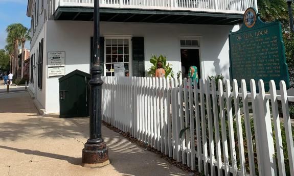 The entrance to the Peña-Peck house is a gate through a picket fence