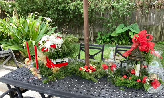 The sunny deck in a Florida home with the table decorated for Christmas