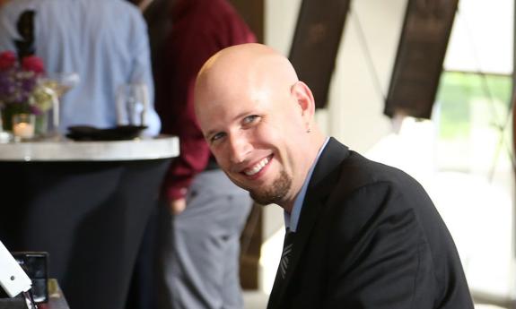 Jeremy Weinglass at the piano, smiling