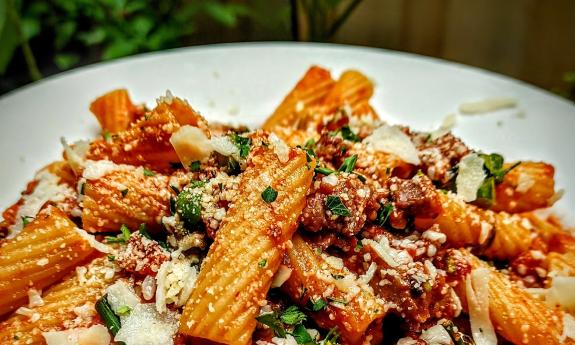 Amici's ziti piled on a white plate