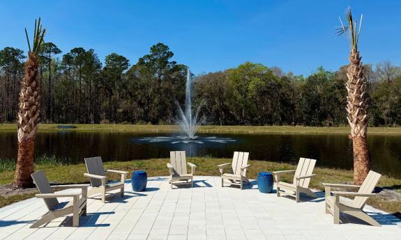 A sunny seating area near the retention pond