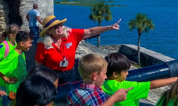 A tour guide points to where the enemy would have been when giving a school tour
