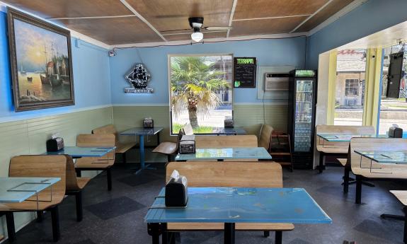 Tables and booths filling the indoor dining space