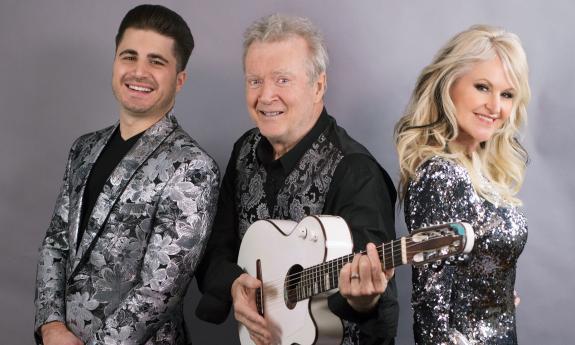 Peter White clutches his guitar and smiles alongside Mindi Abair and Vincent Ingala. 