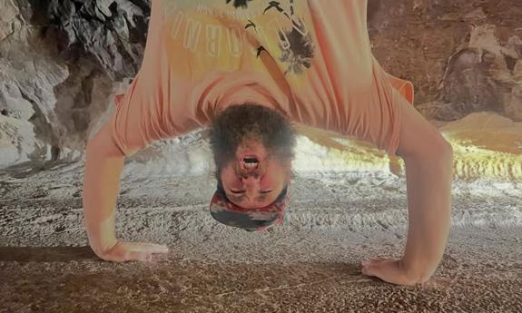 Singer-songwriter Zach Deputy standing on his hands, laughing