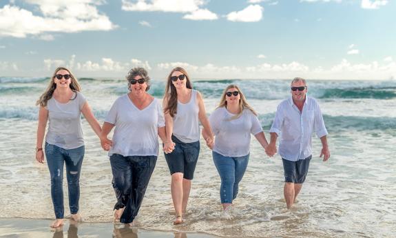 A family walking hand-in-hand on the beach