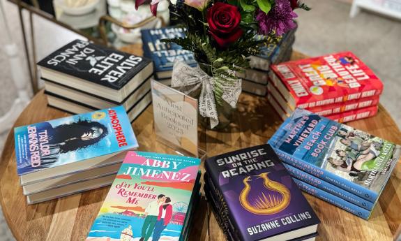 A book display with a floral centerpiece
