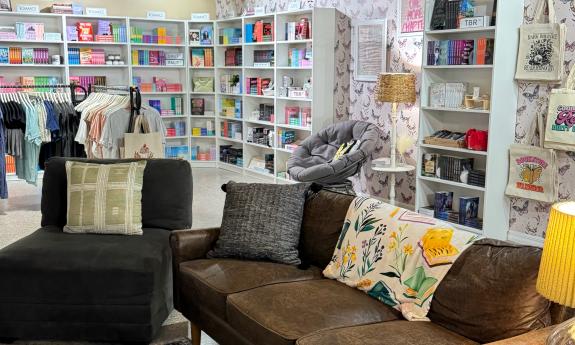 A lounge area with bookshelves lining the walls behind