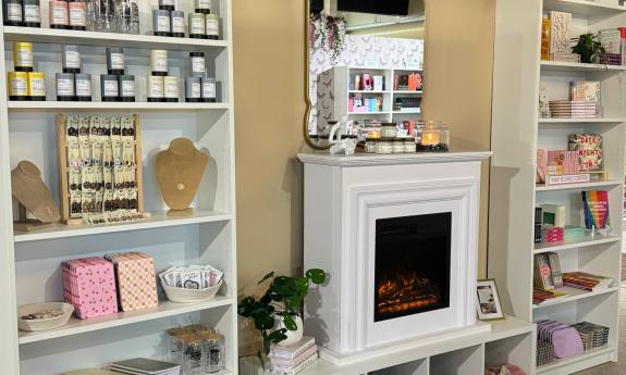 A fireplace with local products presented on both sides of it