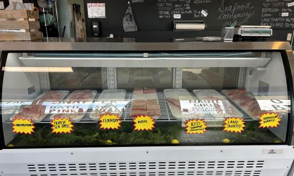 A glass display of all the fresh seafood