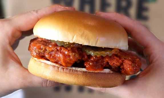 A chicken sandwich with pickles