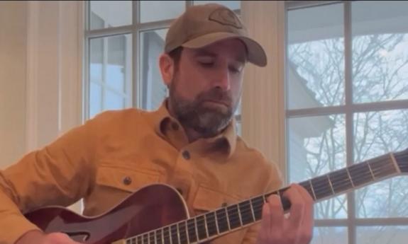 Musician Dave Schottland practicing guitar
