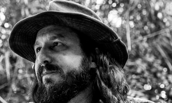 Paul Orehovec in a fedora, looking to the side