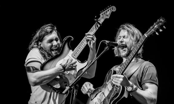 Teskey Brothers on stage with guitars, singing