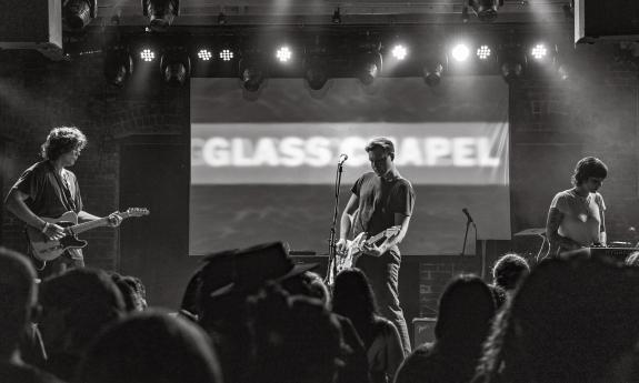 The three members of Glass Chapel on stage in black and white