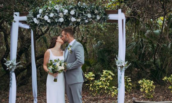 Newlyweds kissing after their ceremony