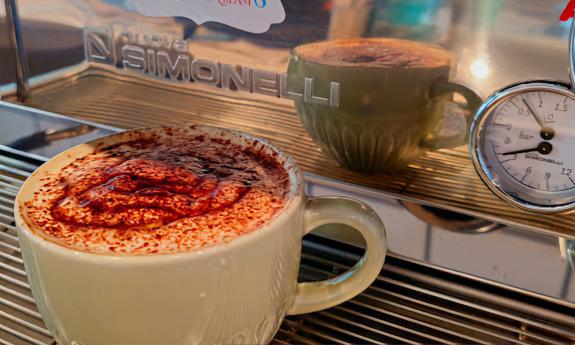 A chocolate latte with additional spices on top