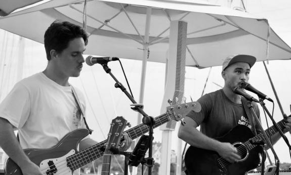 Ragga Surf Music playing outside on stage.
