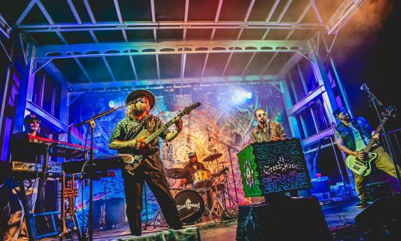 Bandmates from TreeHouse perform live on stage.