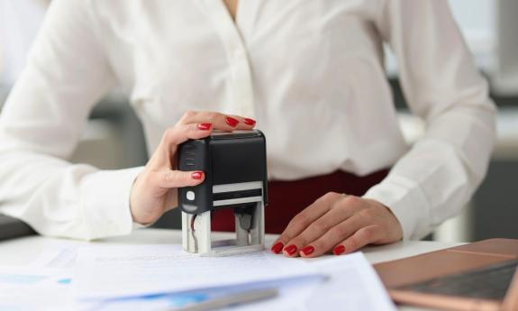 A woman stamping an official paper