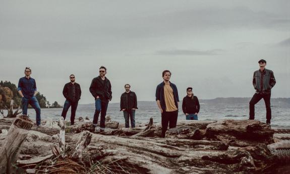 Members of Polyrhythmics on the edge of the ocean 