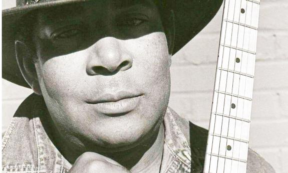 Blues singer Gitlo Lee in hat, with eyes in shadow