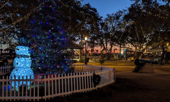 A snowman guards the decorated Christmas Tree during Nights of Lights in St. Augustine