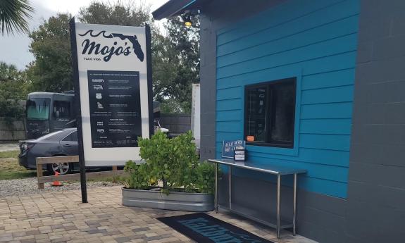 The Mojos sign next to the order window for Kaliburger